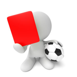 white referee holding soccer ball and showing a red card