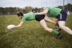 Two females playing rugby